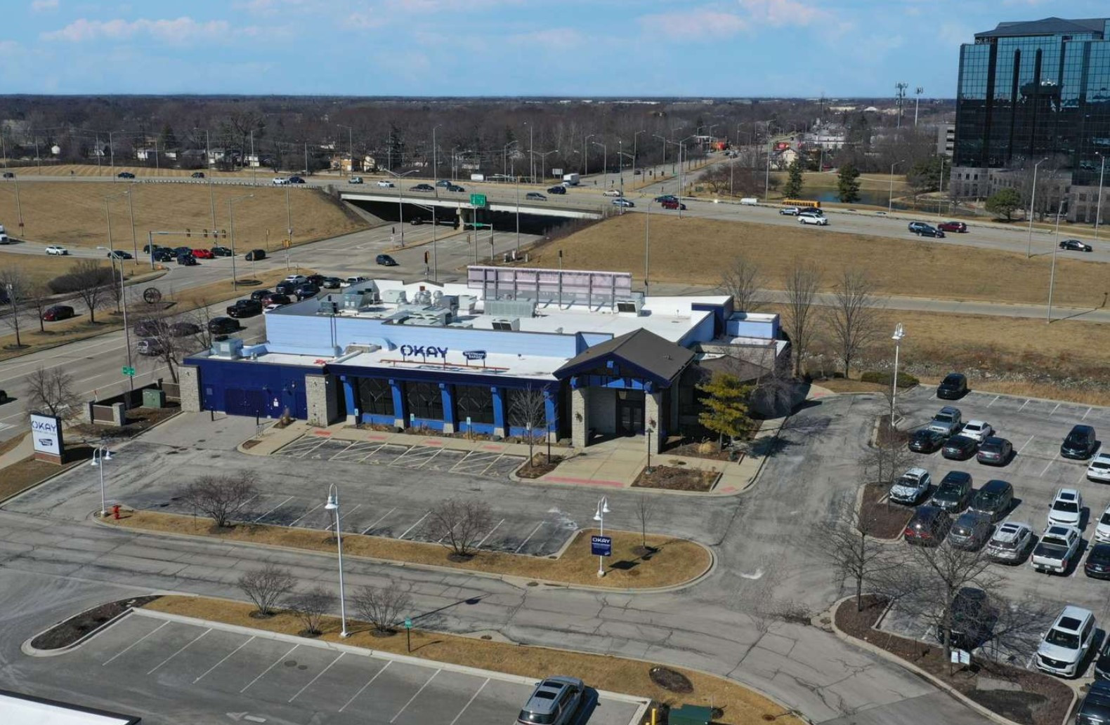 Okay Restaurant Building  aerial view of building, lot and nearby highway overpass
